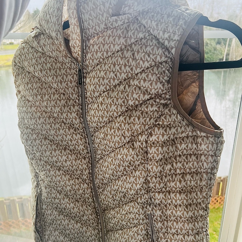 Packable coat with tags attached and Michael Kors letters